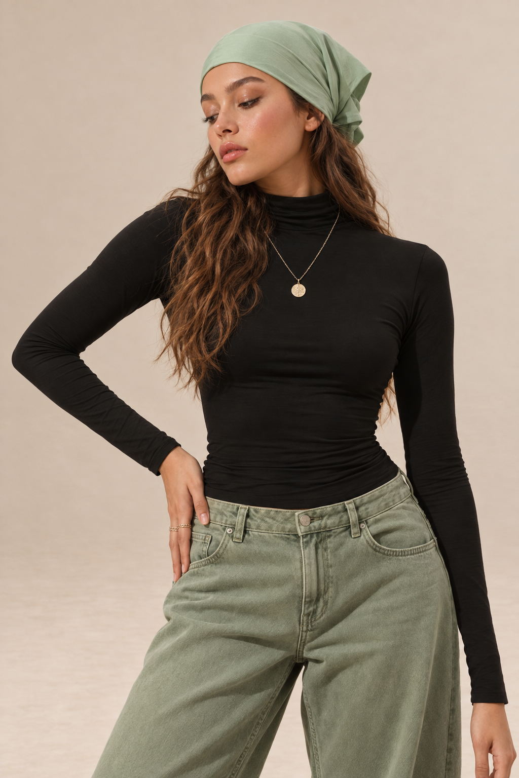 Elara women's black long-sleeve roll neck top with a high neckline, fitted silhouette and plain finish, shown from the front.
