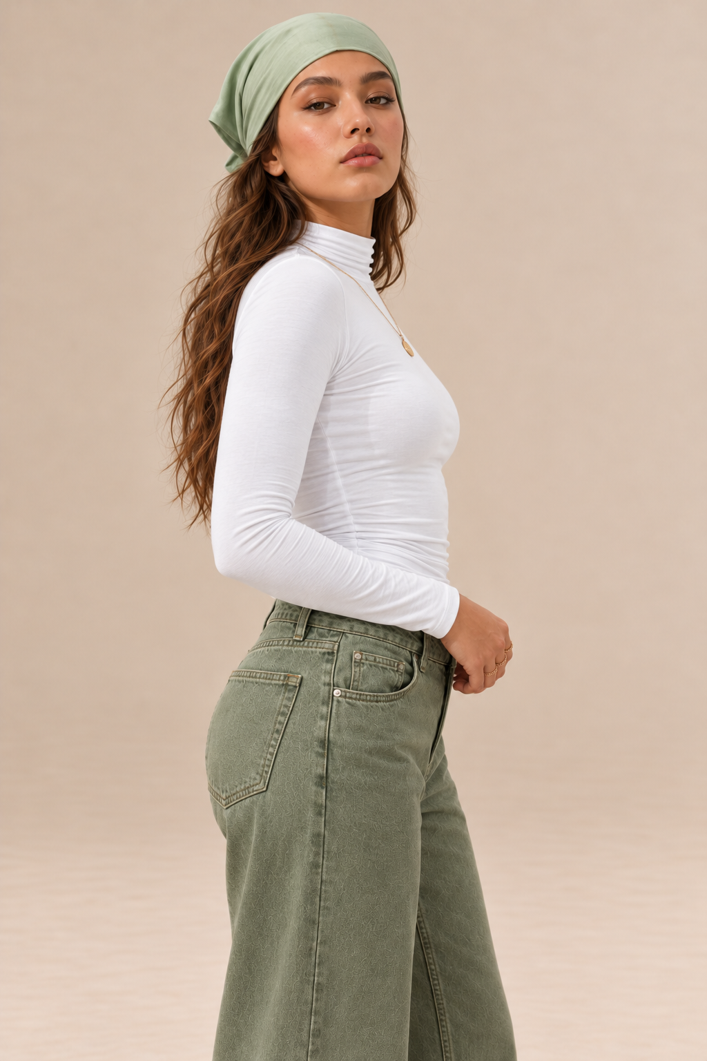 Elara women's white long-sleeve roll neck top with a high neckline and fitted silhouette, side view.