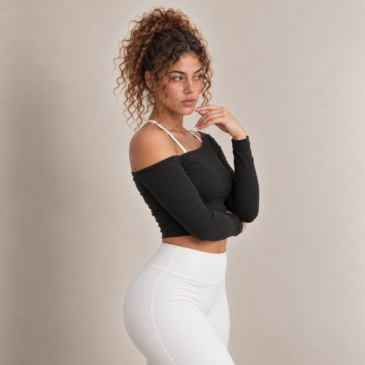 Lyra women's long-sleeve cropped top in black with an off-shoulder neckline and a plain finish, shown in a three-quarter view.