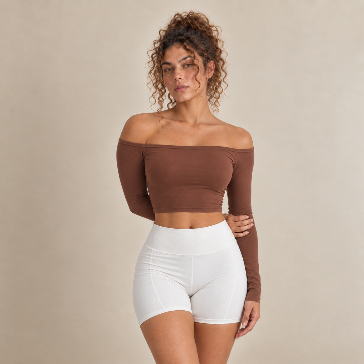 Lyra women's long-sleeve cropped top in brown with an off-shoulder neckline and a plain finish, shown from the front.