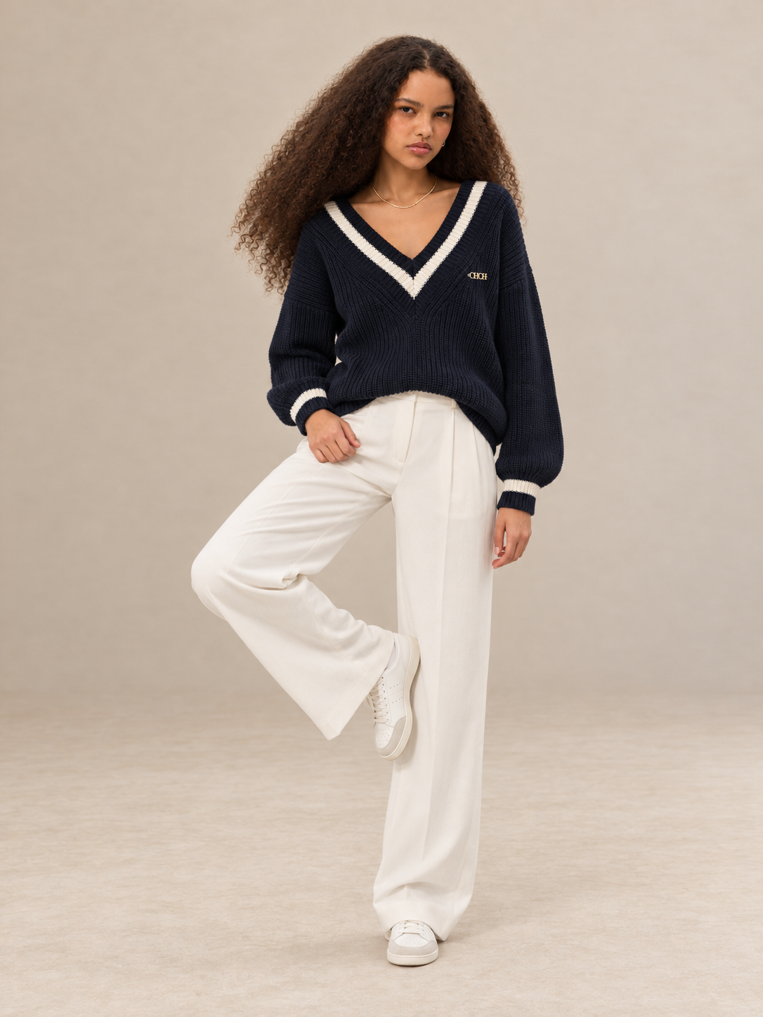 Margot women's navy blue knitted V neck jumper with cream contrast stripes — full-length front view.