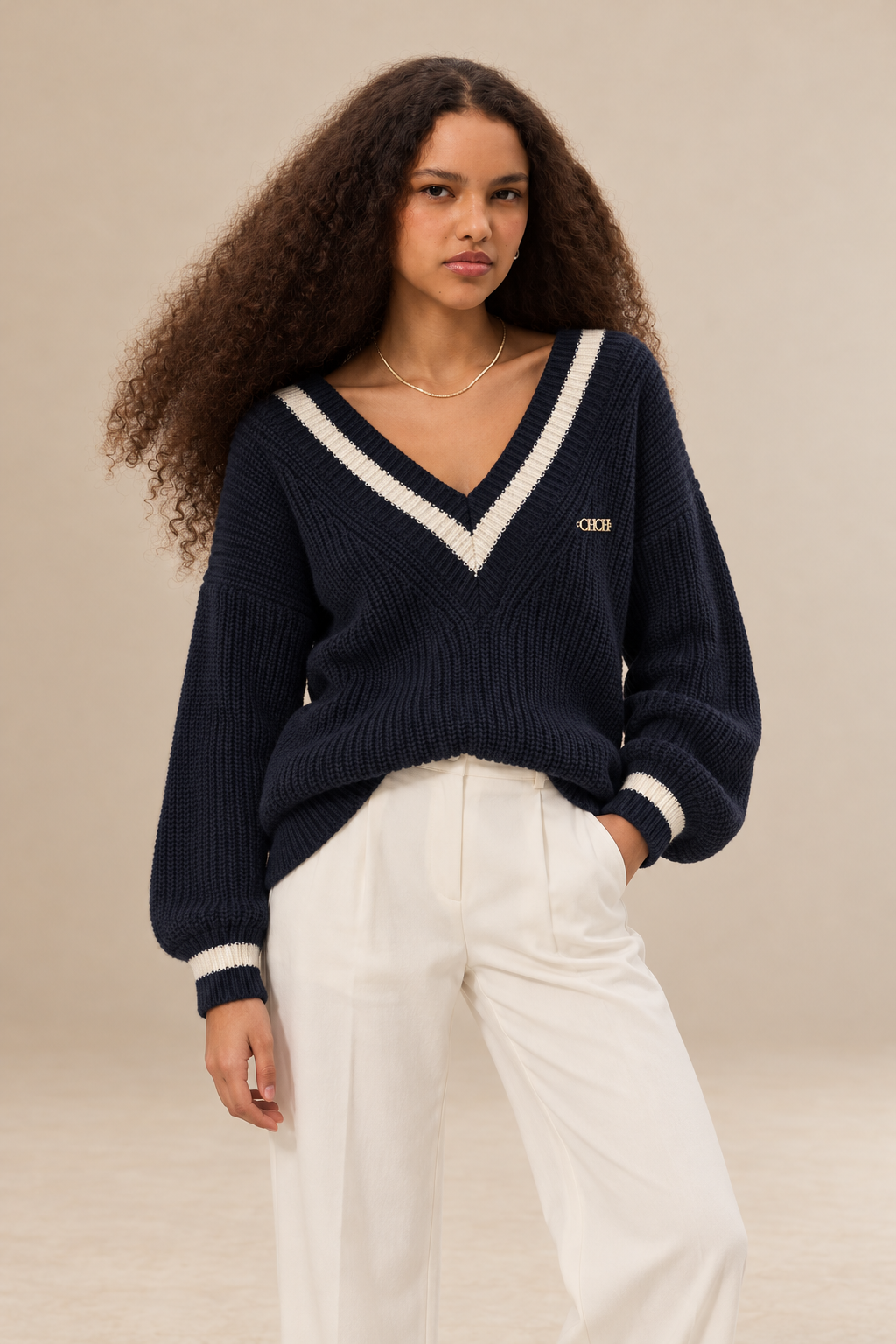 Margot women's navy blue knitted V neck jumper with cream contrast stripes — front view.
