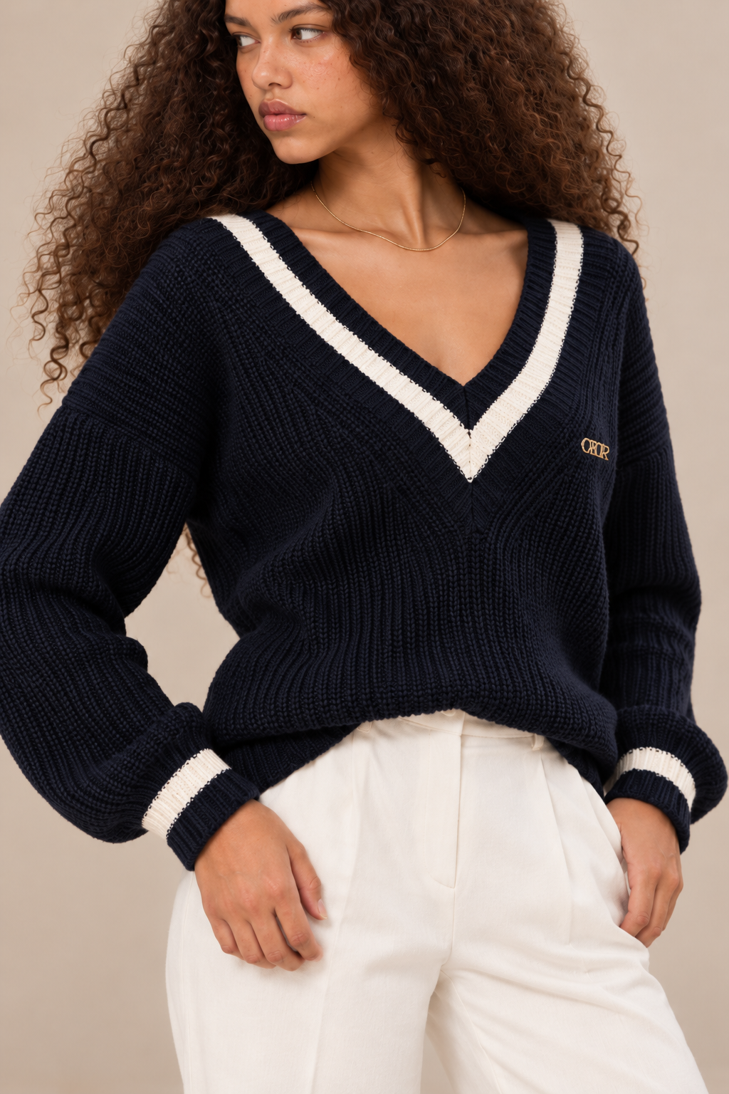 Margot women's navy blue knitted V neck jumper with cream contrast stripes — neckline and cuffs detail.