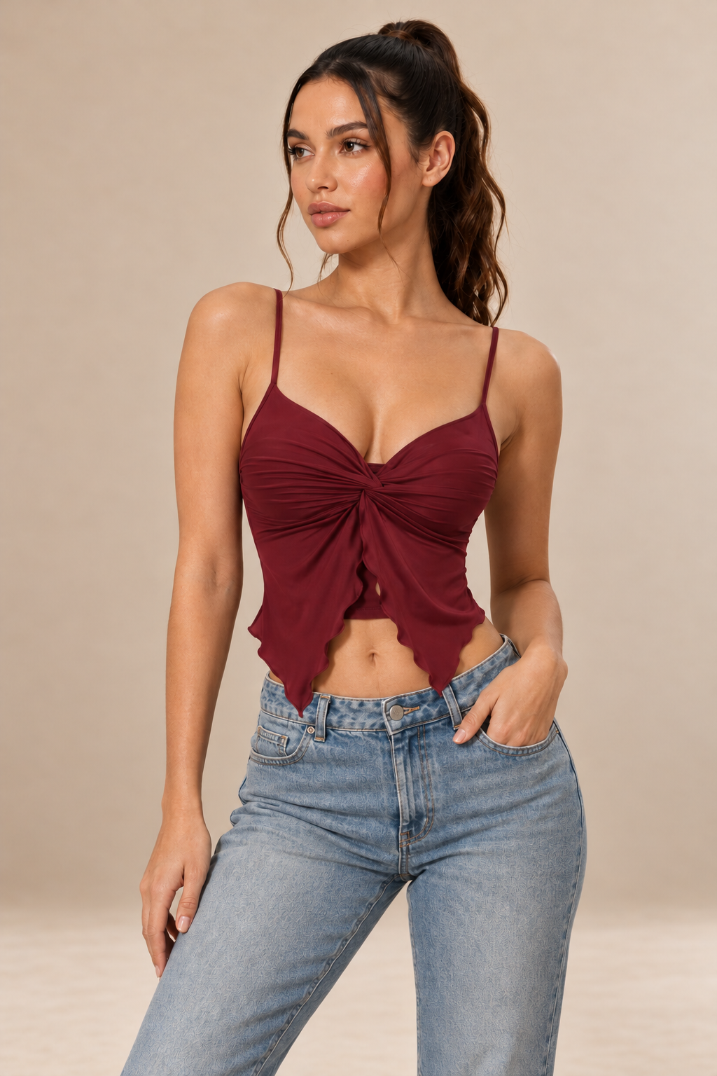 Nora women's twist front cami top in claret, shown from the front with slender straps, a V-neckline, gathered fabric and a pointed asymmetric hem.